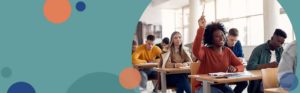 photo of a student sitting at a desk in a classroom with her hand raised | Honor Credit Union