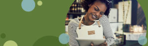 woman holding a tablet device while talking on a phone | Honor Credit Union