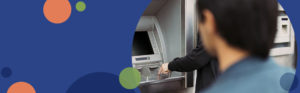 person watching another person enter numbers at an atm machine | Honor Credit Union