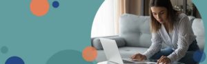 woman sitting on couch looking at paperwork | Honor Credit Union