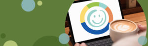 person holding cup of coffee looking at a laptop computer screen | Honor Credit Union