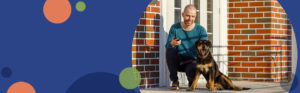 man kneeling down petting a dog | Honor Credit Union