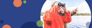 man looking through binoculars | Honor Credit Union