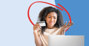a young women looking at her laptop with concern, after noticing credit card fraud on her account | Honor Credit Union