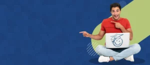 image of a male college student sitting with his legs crossed with a laptop on his lap | Honor Credit Union
