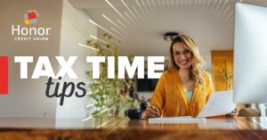 woman sitting at a table doing paperwork | Honor Credit Union