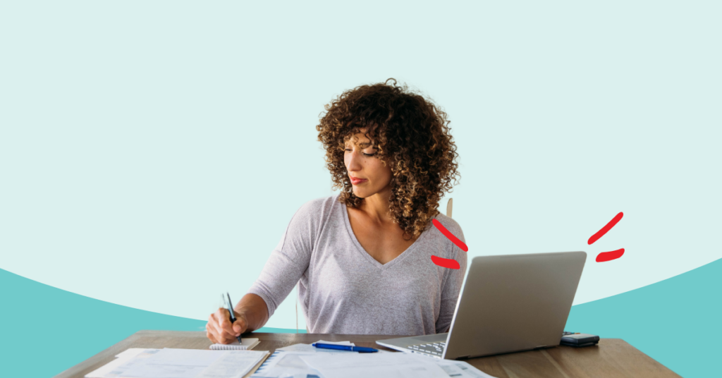 women at a deck writing on a pad of paper with tax documents surrounding her and her laptop