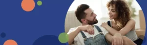 man and woman sitting on a couch holding house keys | Honor Credit Union