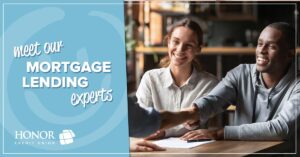 man and woman sitting at a table talking with a mortgage lender | Honor Credit Union