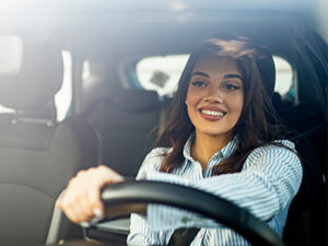 woman smiling while driving a car | Honor Credit Union