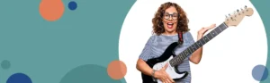woman wearing glasses playing a guitar | Honor Credit Union