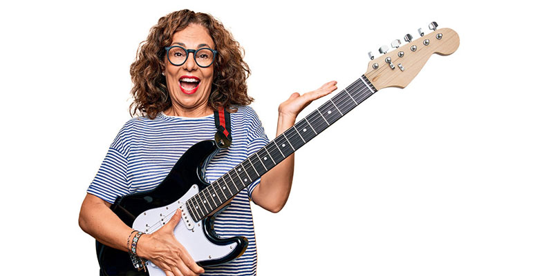 woman wearing glasses playing a guitar
