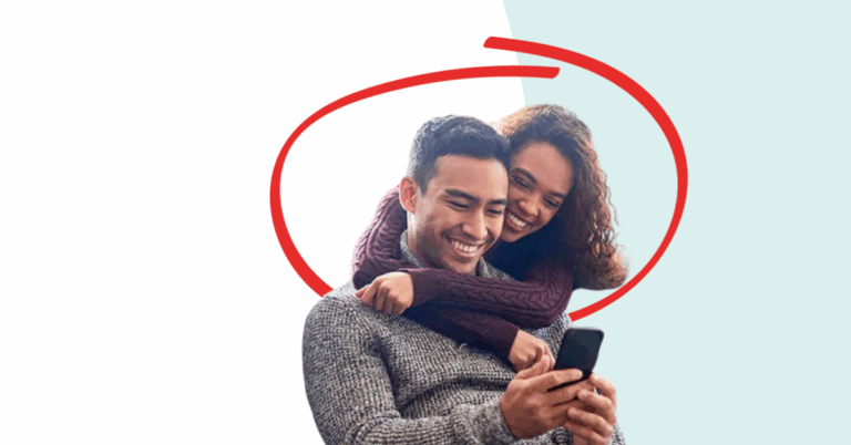 Young couple looking at a phone together happily