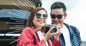 man and woman wearing sunglasses outside using a camera | Honor Credit Union
