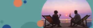 man and woman sitting on a beach watching a sunset | Honor Credit Union