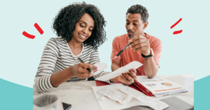 a couple smiling while filing their taxes together | Honor Credit Union