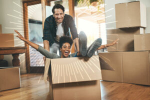 woman sitting in a box being pushed by a man