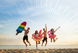 group of people jumping on a beach near the water | Honor Credit Union