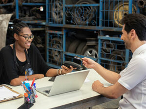 female business owner accepting a payment | Honor Credit Union