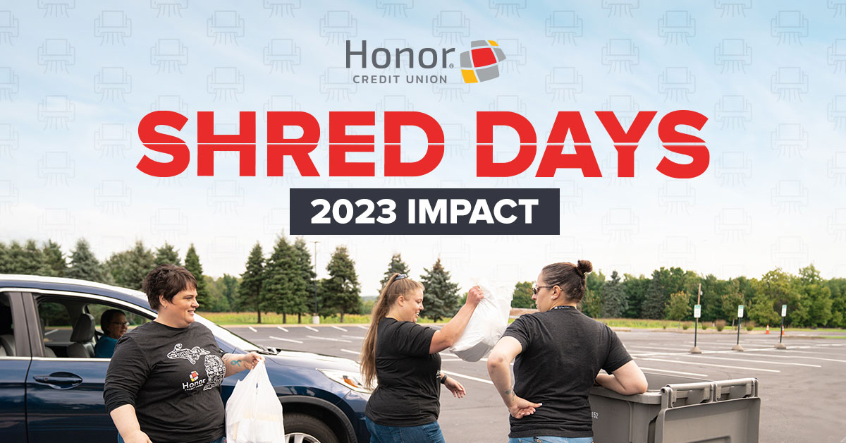 Honor team members unloading paper from a person's car at a shred day event