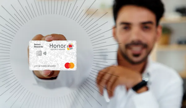 man holding honor select rewards credit card