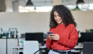 woman looking at her phone | Honor Credit Union