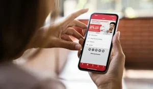 person looking at a phone with the honor mobile app showing on the screen | Honor Credit Union