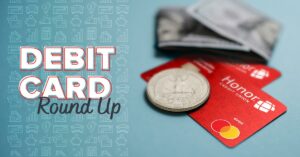 honor debit cards with a quarter laying on them | Honor Credit Union