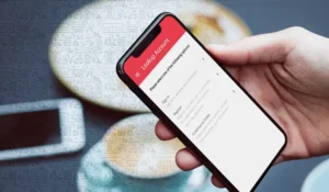 smartphone in a hand with loanpay xpress showing on the screen | Honor Credit Union