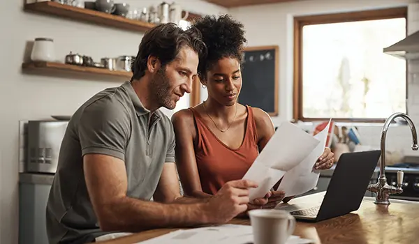 man and woman looking at paperwork at a table