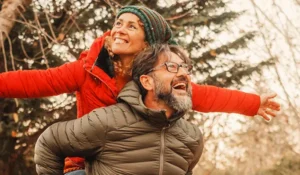middle-age couple smiling while hiking | Honor Credit Union
