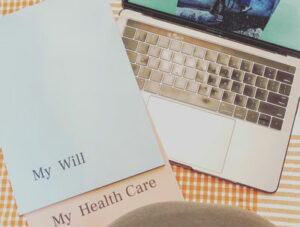 laptop on a table next to will and trust documents | Honor Credit Union