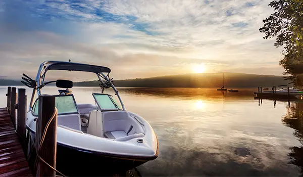 boat tied to a dock during sunset