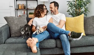 man and woman sitting on a couch smiling at each other | Honor Credit Union