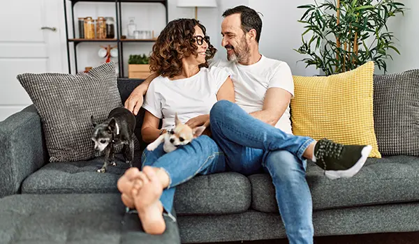 man and woman sitting on a couch smiling at each other