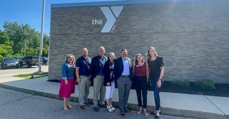 honor credit union and united federal credit union pose with ymca officials for a photo