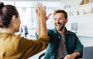man and women high fiving | Honor Credit Union