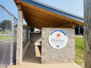 Sign that says "Dugout Sponsor Honor Credit Union" Negaunee Little League Dugout Construction | Honor Credit Union