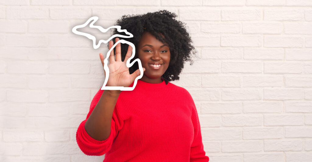 member holding up a hand with an outline of the state of Michigan around her hand