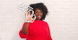 member holding up a hand with an outline of the state of Michigan around her hand | Honor Credit Union