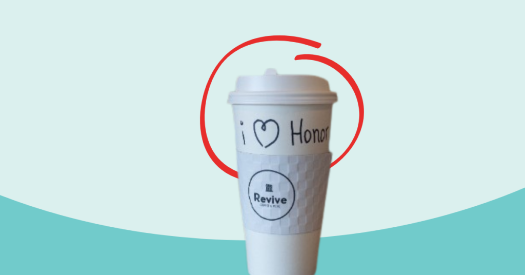 to go cup of coffee that says Revive, and I heart Honor