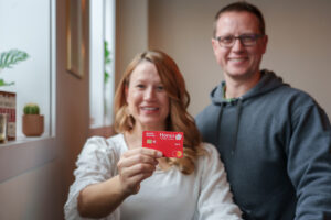 couple holding up an Honor debit card | Honor Credit Union