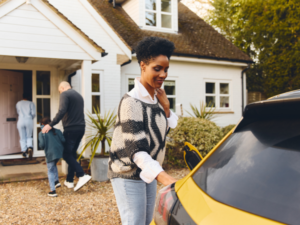 women with a yellow car | Honor Credit Union