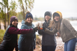 four Honor team members cheersing Biggby Coffee cups | Honor Credit Union