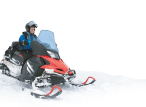 man driving a red snowmobile smiling | Honor Credit Union