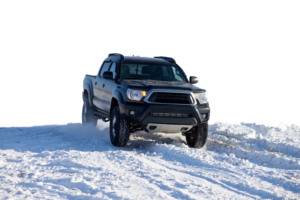 black truck driving in snow