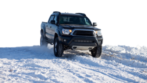 black truck driving in snow