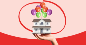 hand holding a miniature house with ballons suspended from the roof | Honor Credit Union