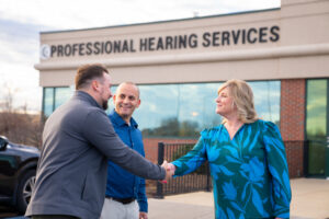 outside of professional hearing services, Honor Team members shaking hands with staff | Honor Credit Union