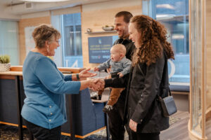 couple with a baby being greeted at an Honor branch | Honor Credit Union